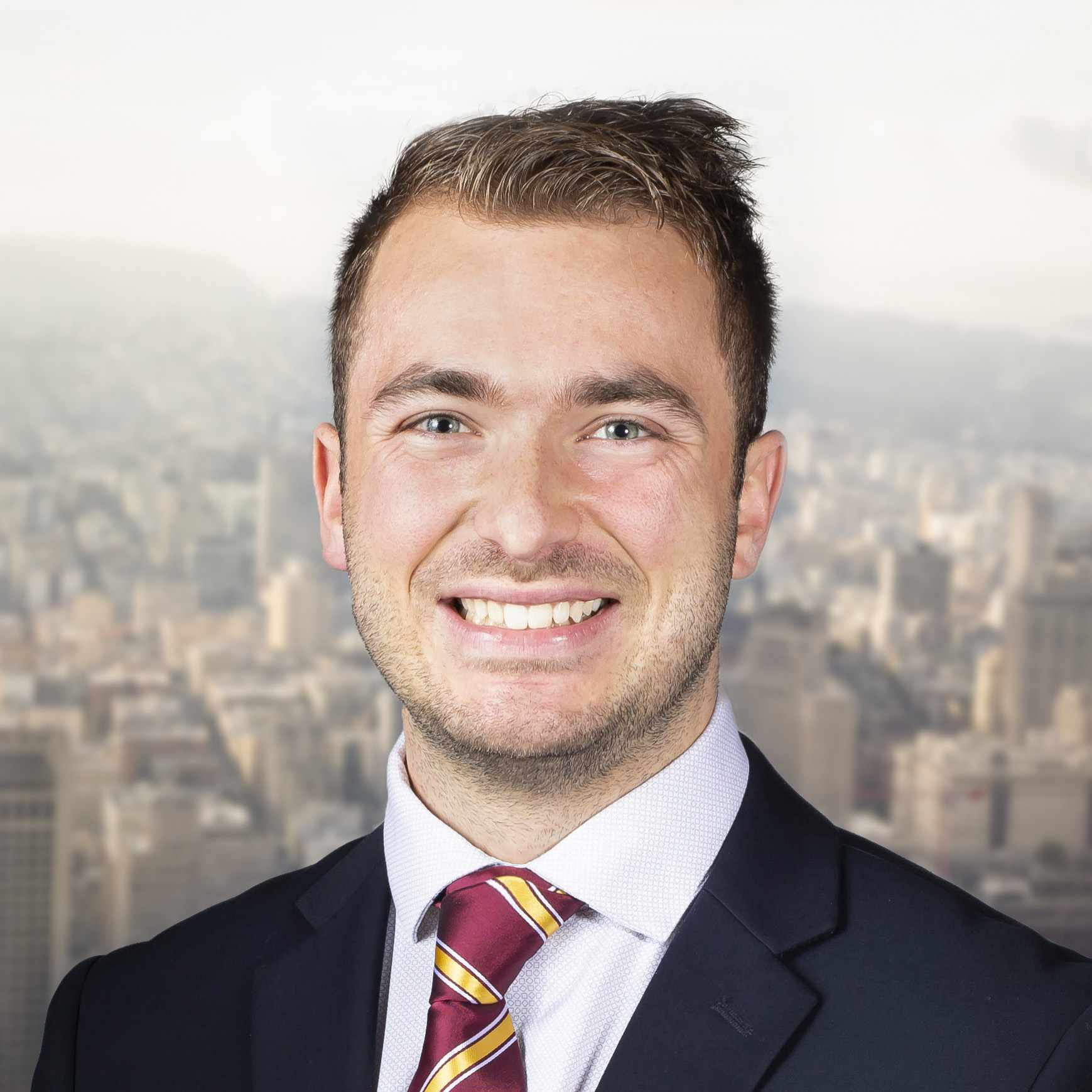 Professional headshot of Billy Hardiman with San Francisco skyline in the background