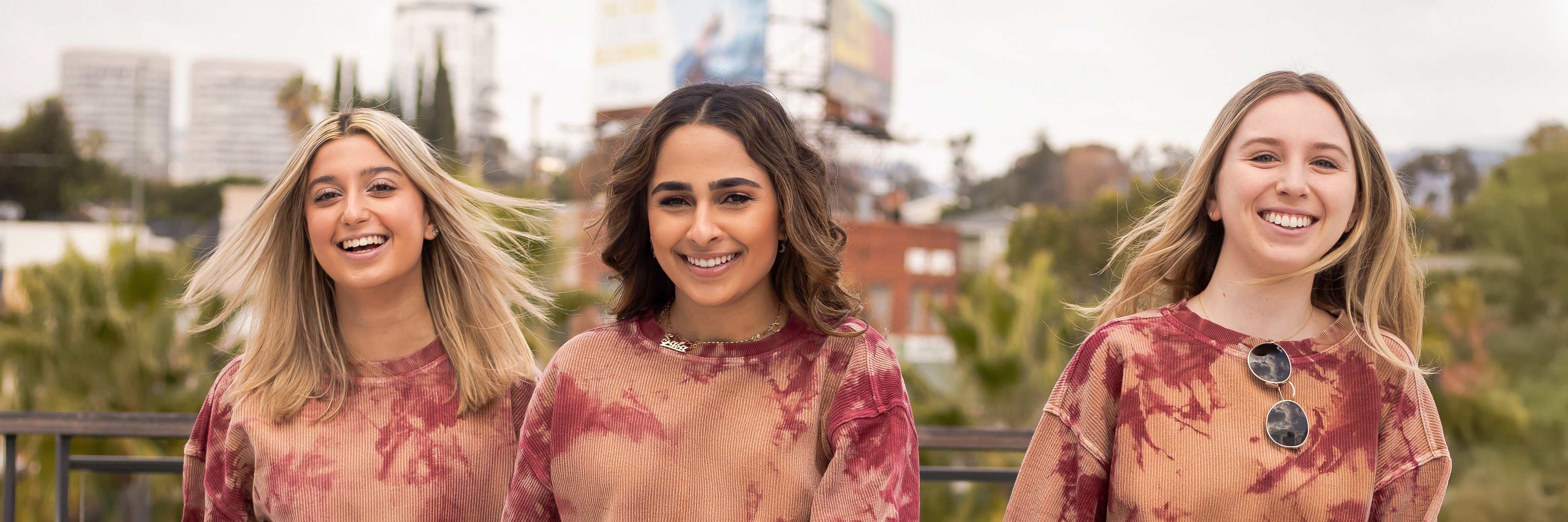 College friends in matching tie-dye outfits walking at Westfield Century City outdoor mall