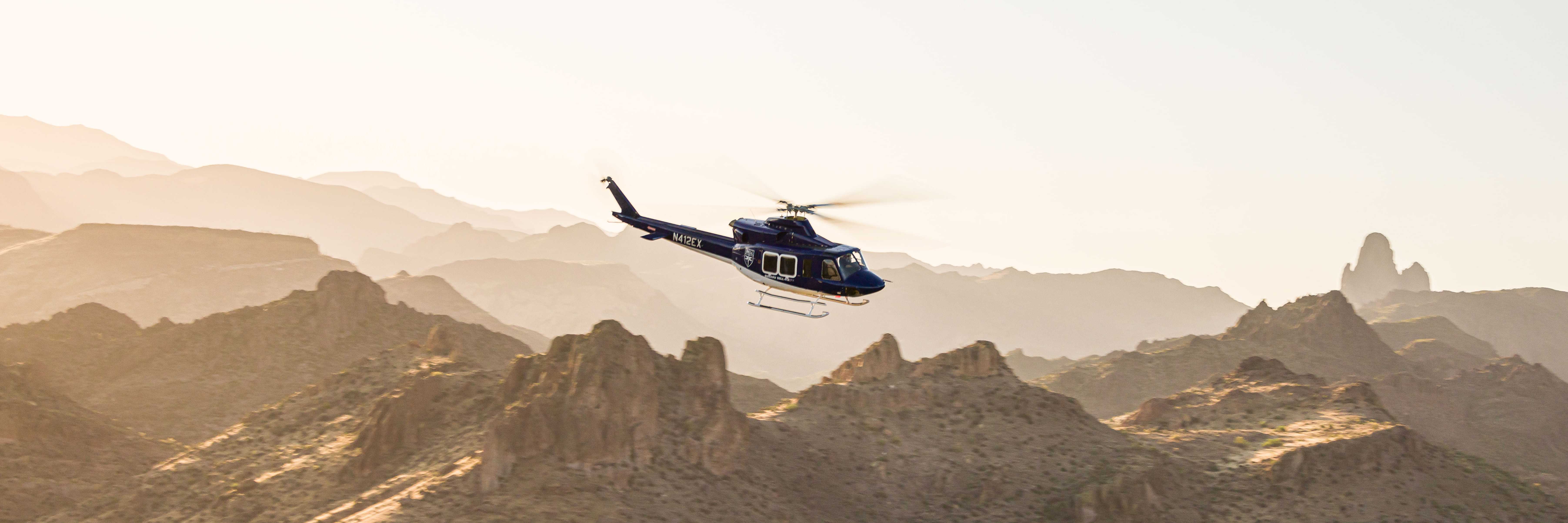 Subaru Bell 412EPX helicopter flying over Arizona desert in morning light