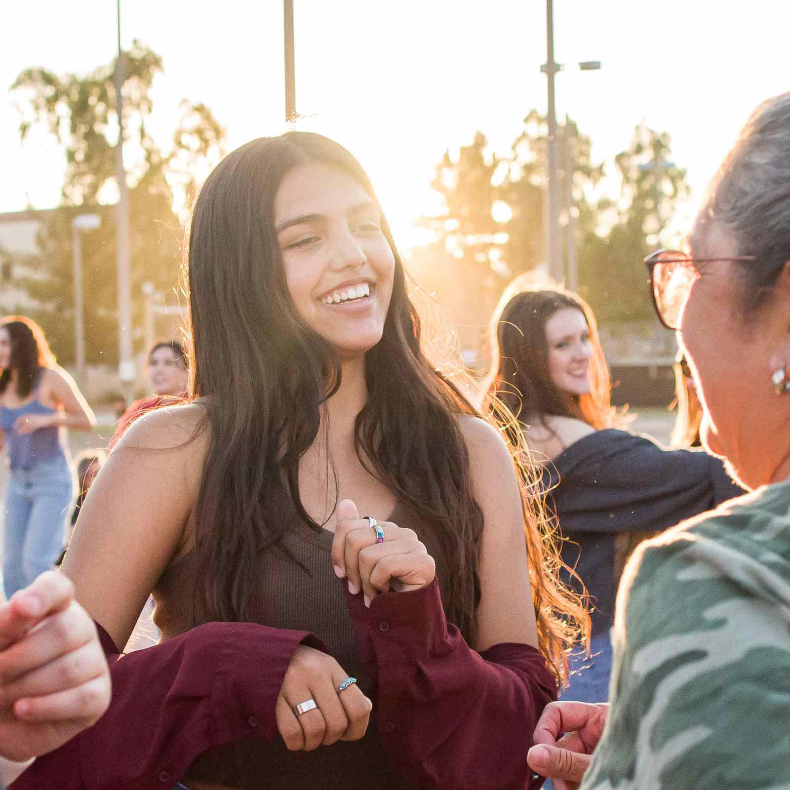 Group of people dancing at sunset in a neighborhood park in Tempe, Arizona