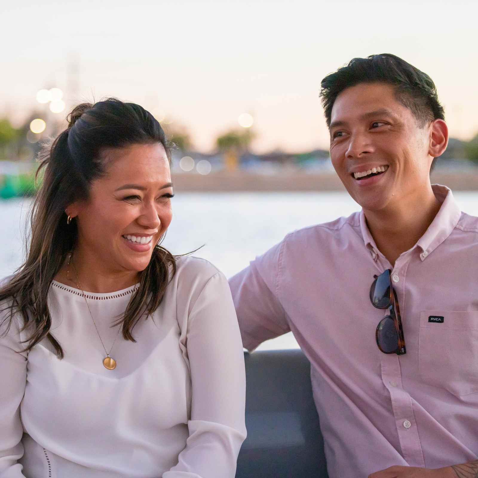 Couple smiling on an evening boat ride on Tempe Town Lake in Arizona