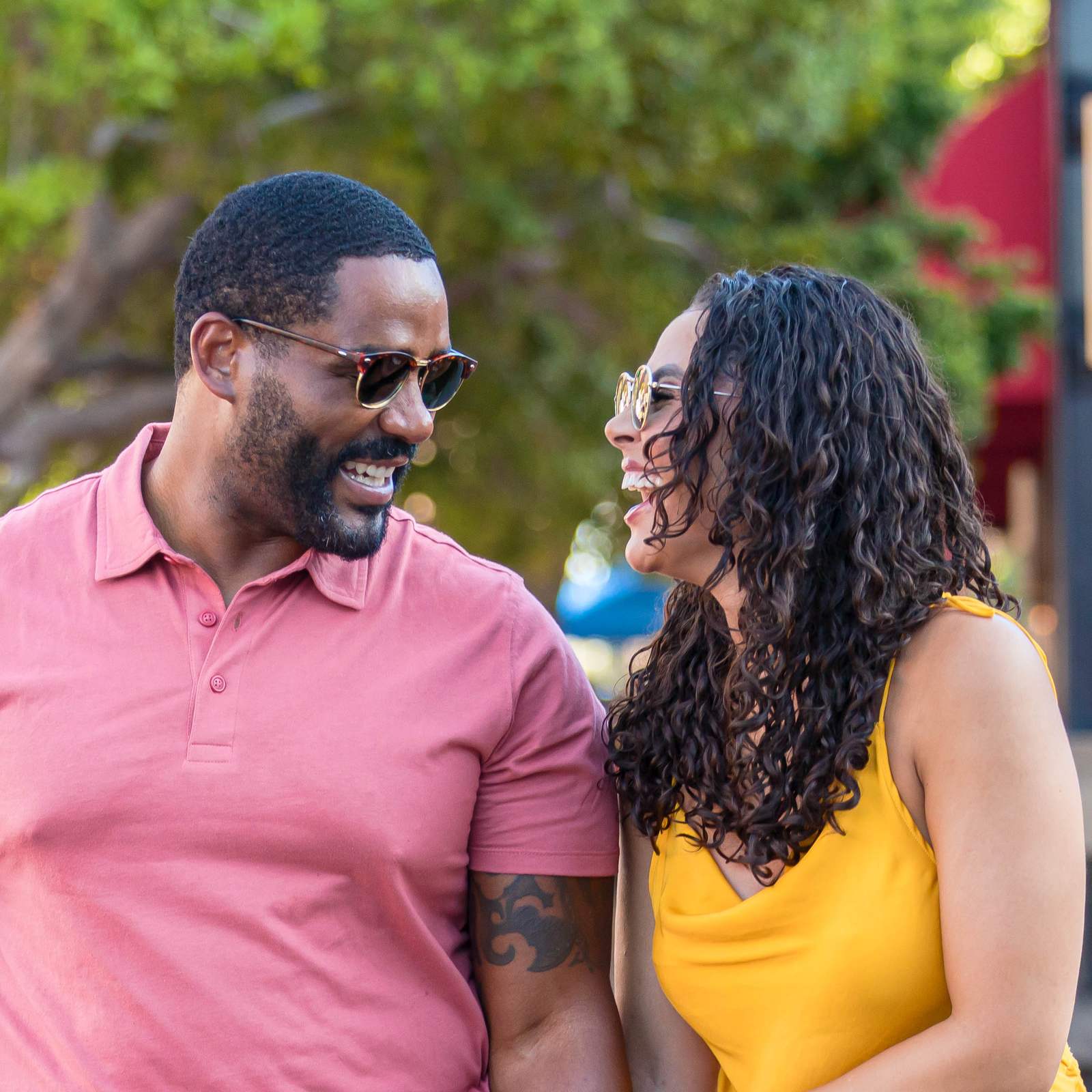 African-American couple smiling while walking down Mill Avenue in downtown Tempe, Arizona