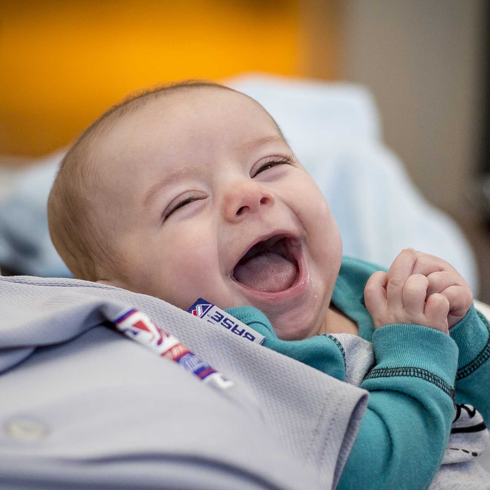 Laughing baby captured at eye level