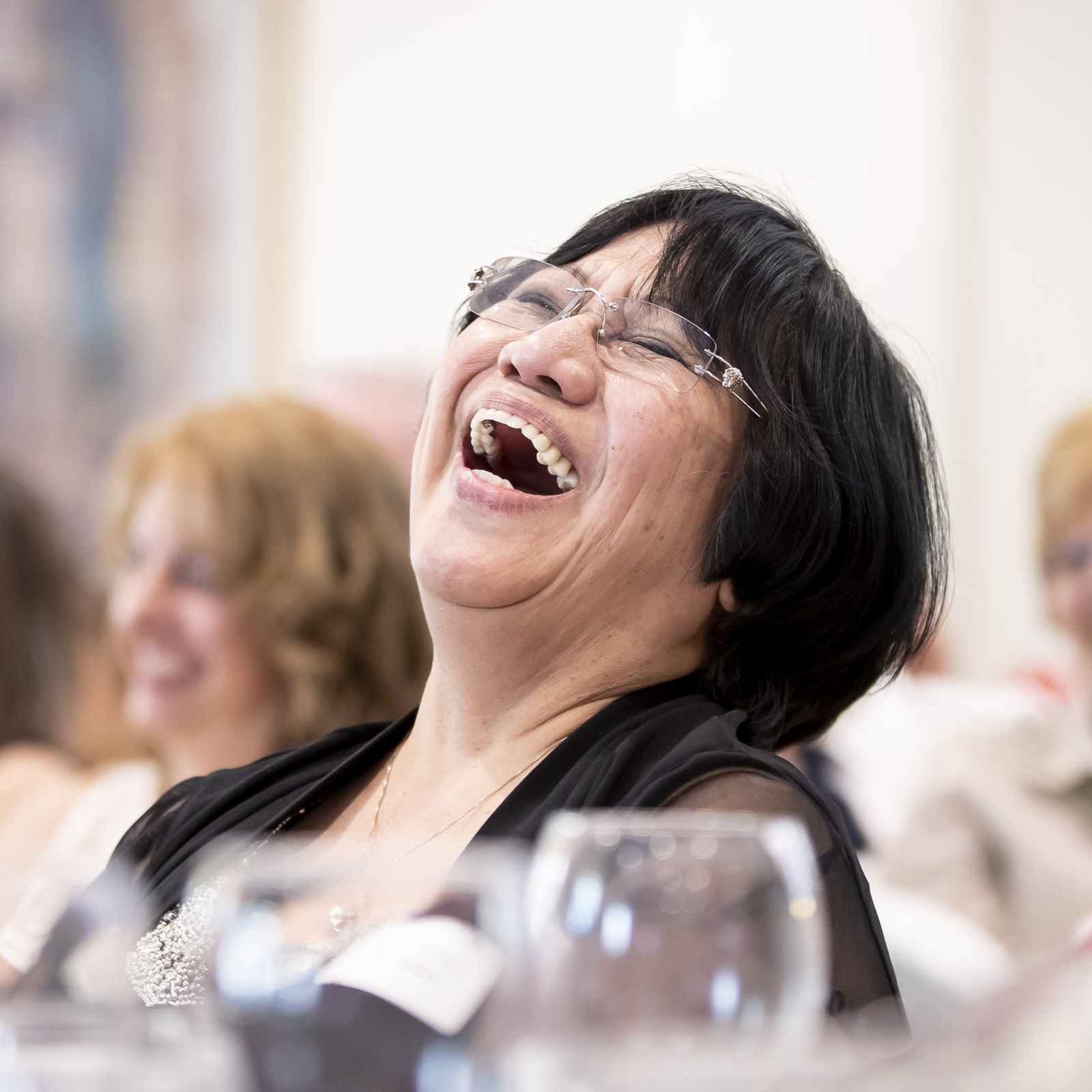 Parishioner laughing during a Catholic church event with others in the background