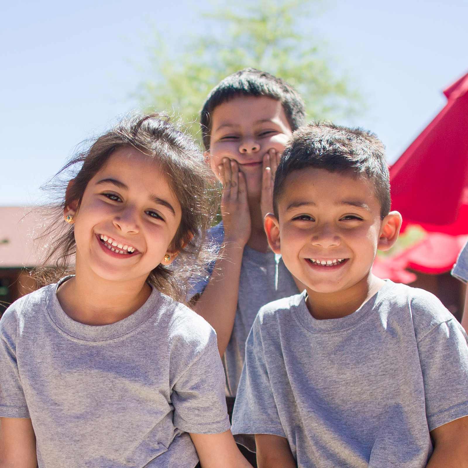 Group of students smiling and being playful in PE uniforms in Phoenix, Arizona