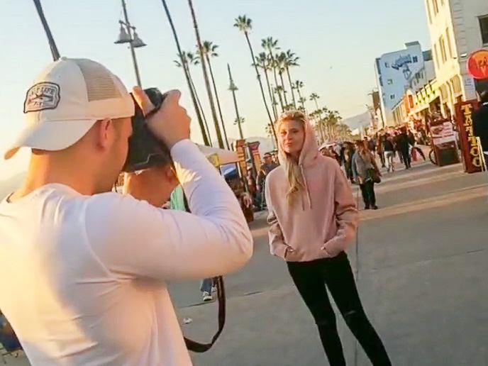 Billy Hardiman photographing a model on Venice Beach Boardwalk for clothing brand