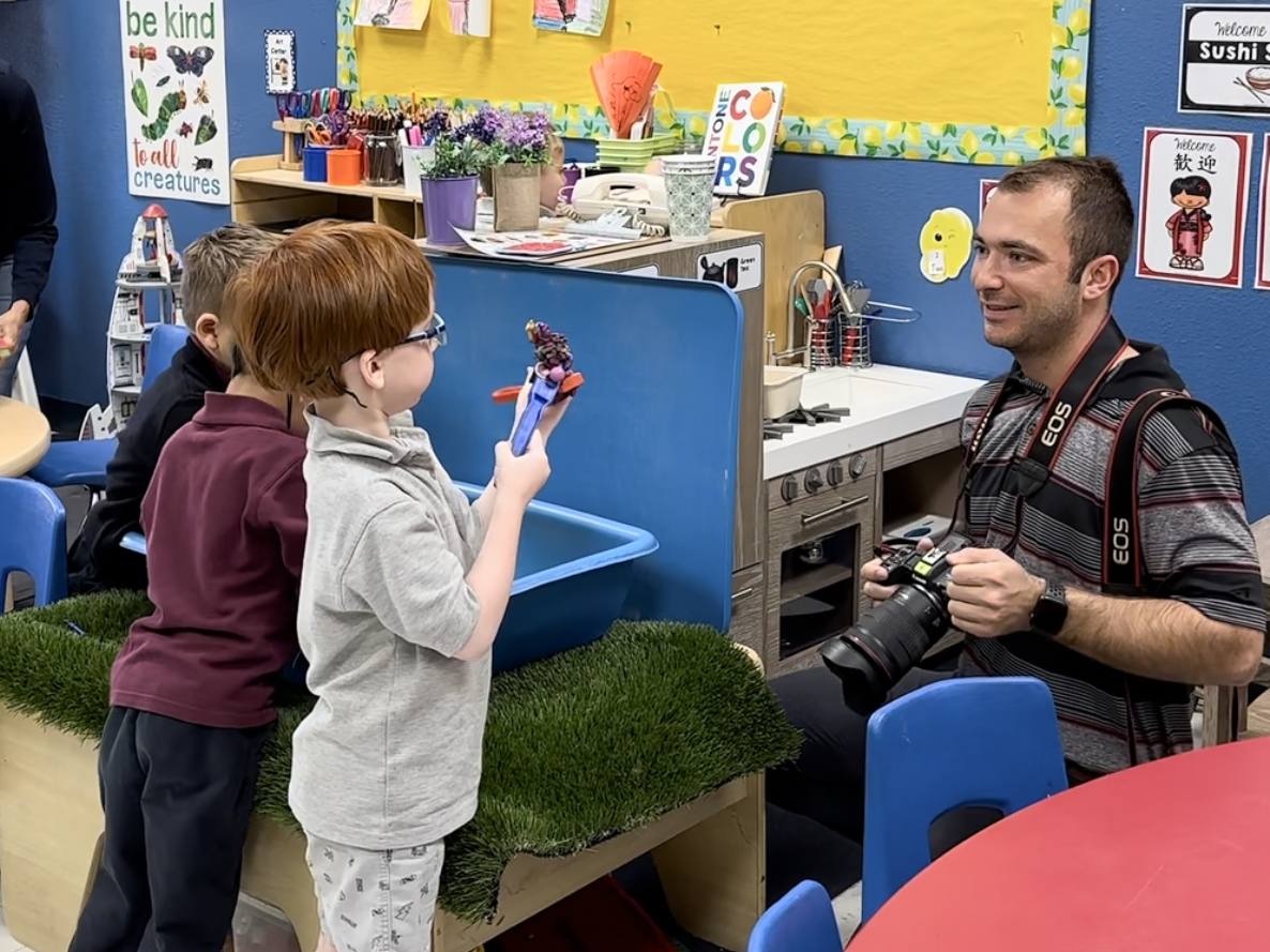 Billy Hardiman photographing and interacting with elementary students in a classroom in Phoenix