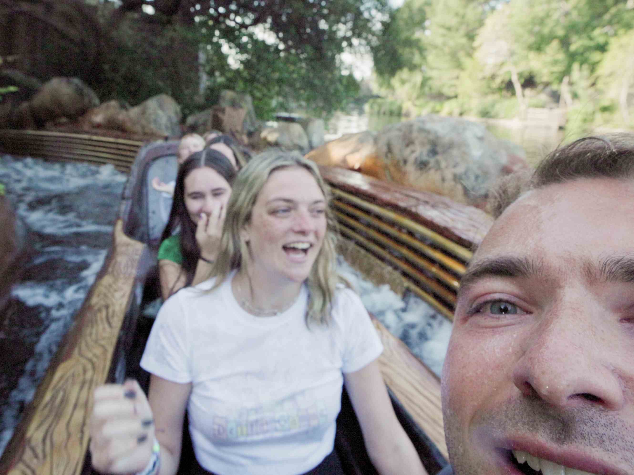 Billy Hardiman pausing for a photo on Splash Mountain with models at Disneyland