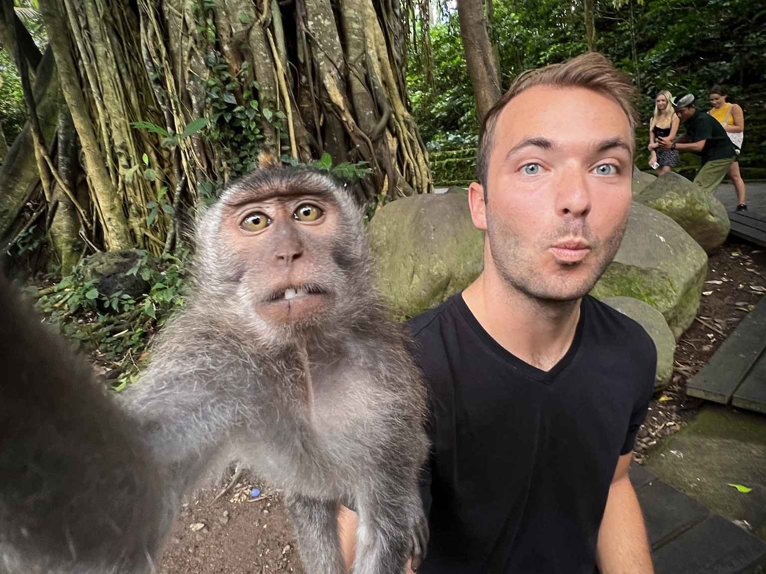 Billy Hardiman with a monkey on his arm at Monkey Forest in Ubud, Bali